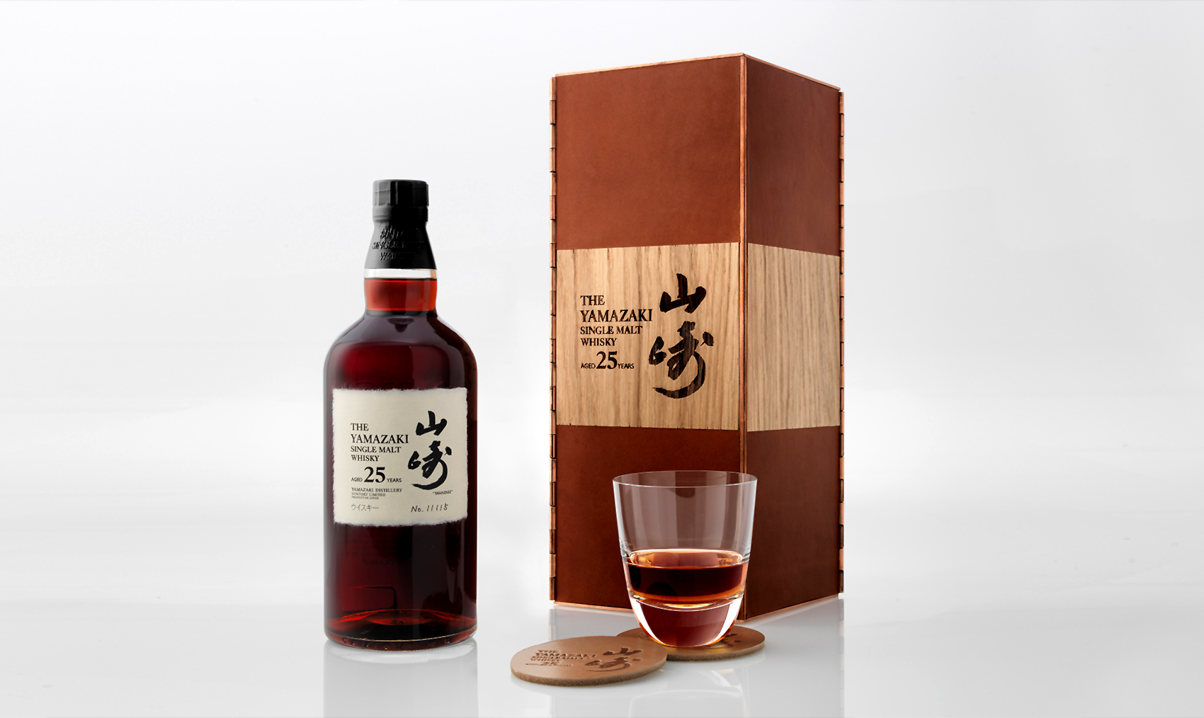 The whisky poured into a glass, beside its box and bottle. The whisky poured into a glass, beside its box and bottle.